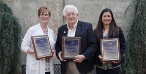 Distinguished Alumni inductee Kenneth Hackman poses with, from left, Julie Ortmann Waltman, representing inductee Coleen Ortmann Kayden, and inductee Tracy Goodman.
